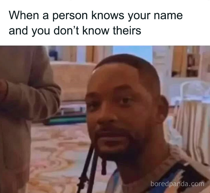 Man with unsure expression in a living room meme highlighting social anxiety moments about forgetting names in social situations.