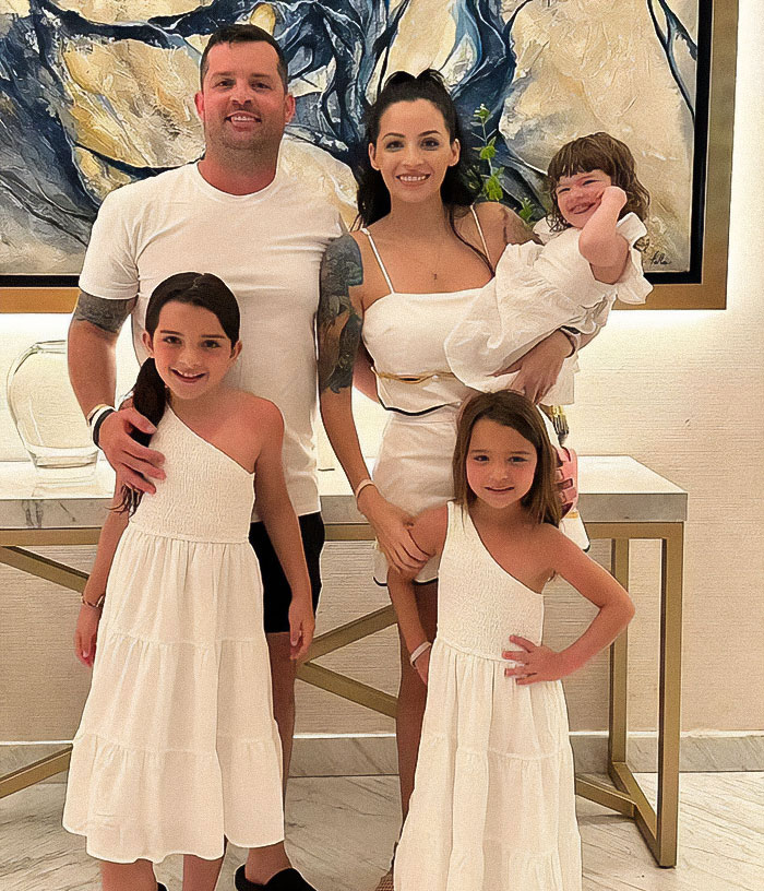 Family portrait with parents and three children, illustrating mass outrage over baby left in car incident. Family portrait with parents and three children, illustrating mass outrage over baby left in car incident.