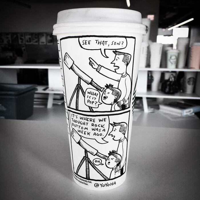 White coffee cup featuring a cartoon comic strip with a telescope and two characters, showcasing relatable cartoon art.