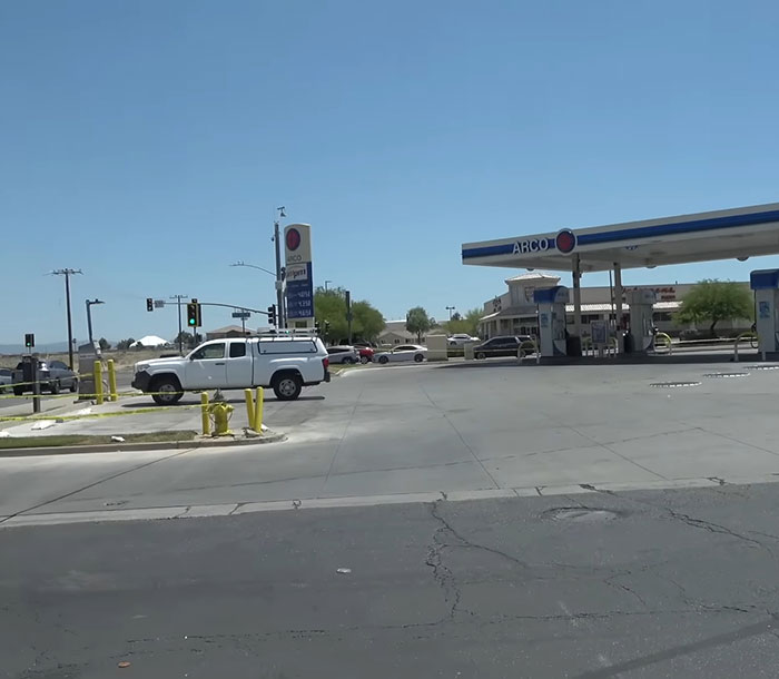 ARCO gas station outside view with parked trucks and clear sky where teddy bear covered in human remains was found
