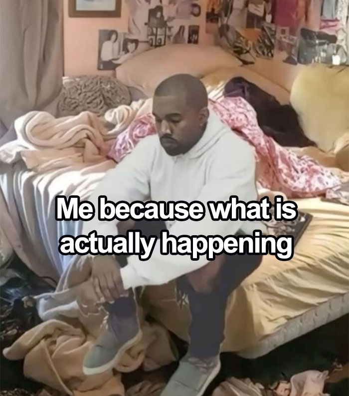 Man sitting on the edge of a messy bed wearing a white hoodie, representing nerdy and weird memes about confusion.