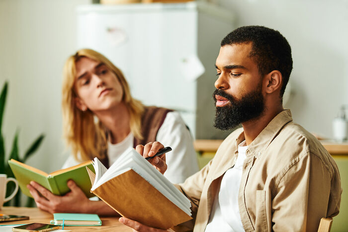 Two people sharing stories and reading books in a cozy room, illustrating people who ran away from home experiences. - 4