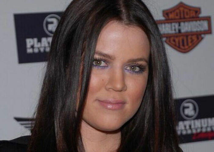 Close-up of a woman with long dark hair and purple eye makeup at an event, related to KarJenner clan controversies. - 25