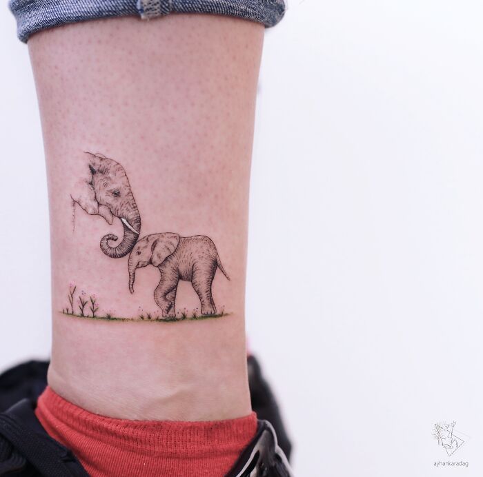 Delicate elephant tattoo on ankle featuring a baby elephant with its mother, a creative design among the best tattoos loved by many.