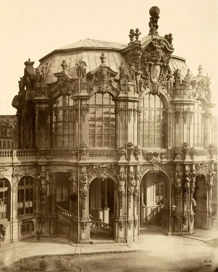 Ornate old architecture with detailed sculptures and large arched windows showcasing historical design and craftsmanship.