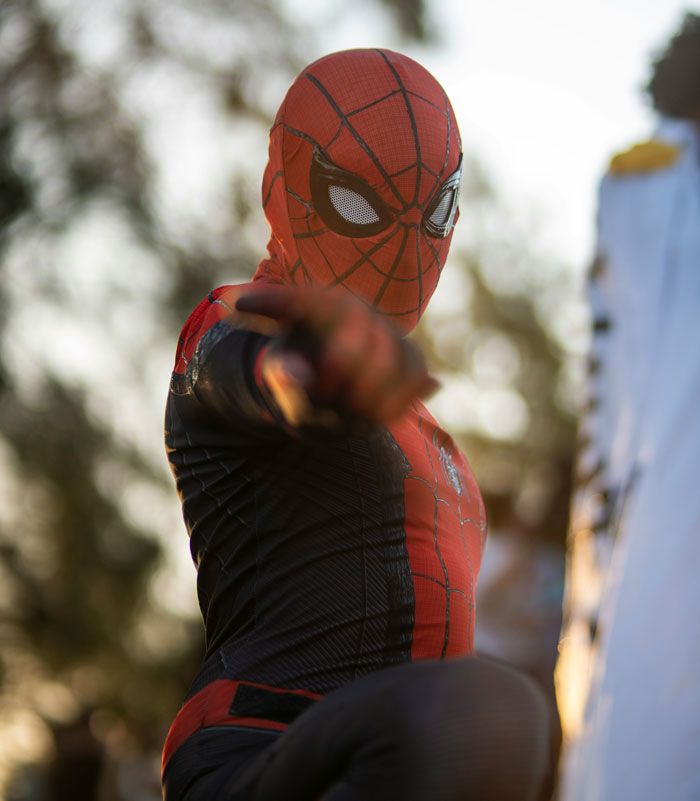 Person dressed as Spider-Man pointing forward outdoors, related to 100 times people regretted accepting a wedding invitation. - 39