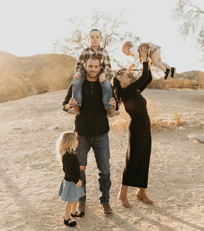 Woman with 3 kids outdoors, smiling after mommy makeover, showcasing stunning transformation and joyful family moment.