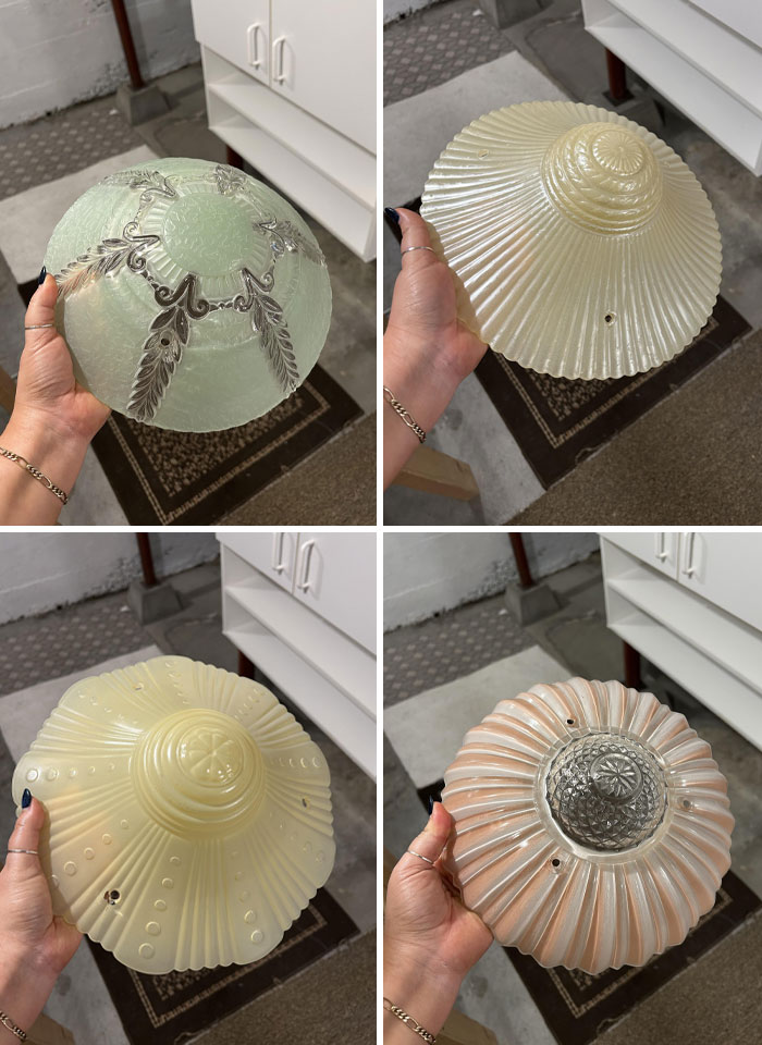 Vintage glass light shades discovered in old homes, showcasing unique designs and intricate details under the floor boards.