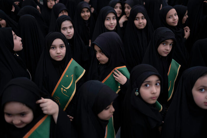 Young girls in black hijabs gathered in a crowd highlighting resurfaced case of 17YO mom brutally assassinated by husband.