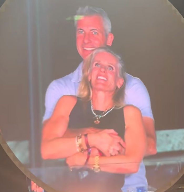 Couple embracing and smiling, related to Coldplay HR exec mortgage controversy and financial issues. - 4