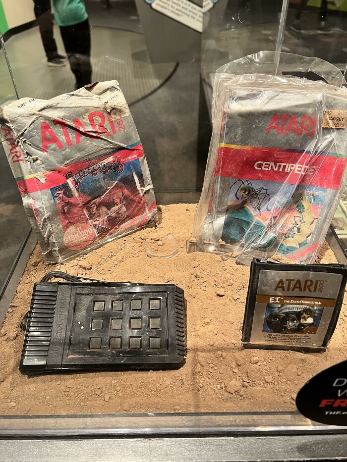 Atari game cartridges and console buried in dirt, related to rumors that turned out to be completely true.