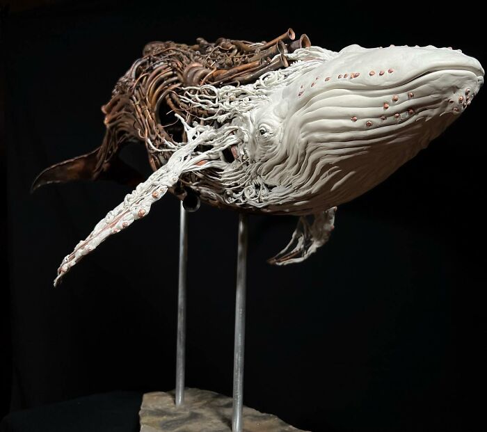 Whale sculpture made from scrap metal showing striking animal sculpture craftsmanship with detailed openwork design.