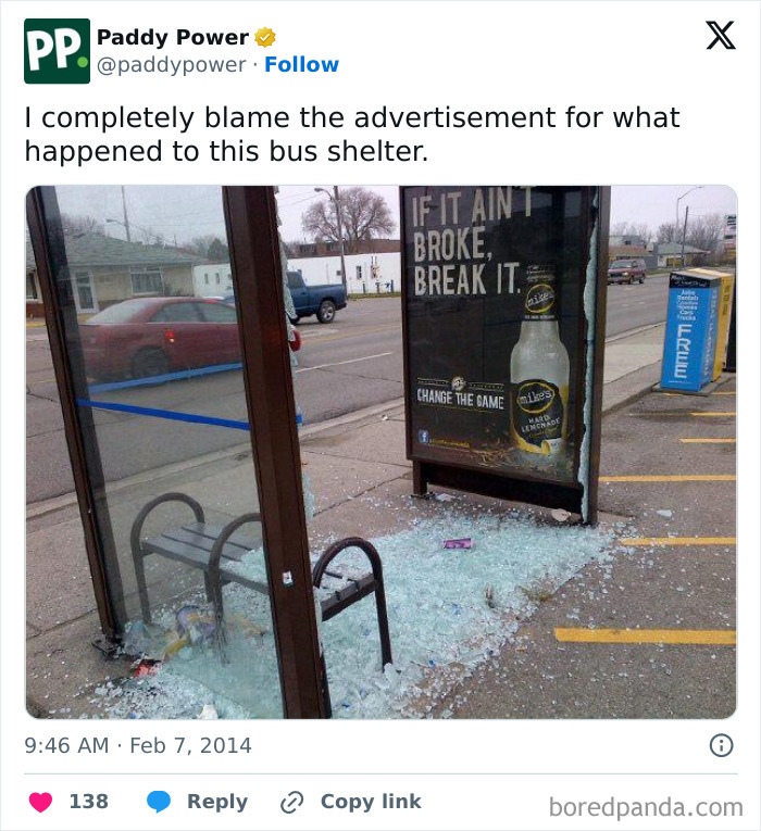 Bus shelter with broken glass and damaged advertisement showing a weaponized portrayal of unattainable body image in advertising fails.