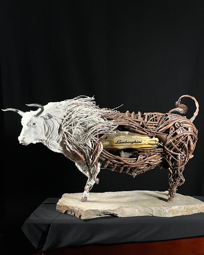 Metal bull sculpture made from scrap metal with intricate details showcasing striking animal sculptures art.