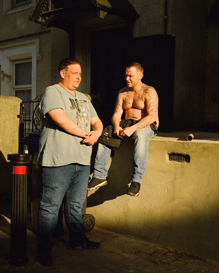 Two men in casual clothing captured in honest photos of London street life by Nico Froehlich.