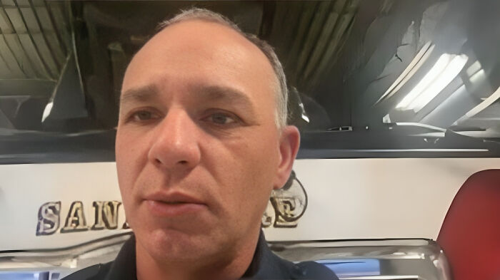 Middle-aged man indoors with industrial ceiling lights, illustrating consequences of stupidity leading to job loss.