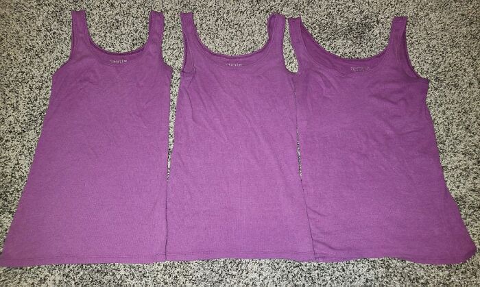 Three identical purple tank tops laid out on a carpet, showcasing a real-life glitch in the matrix moment.