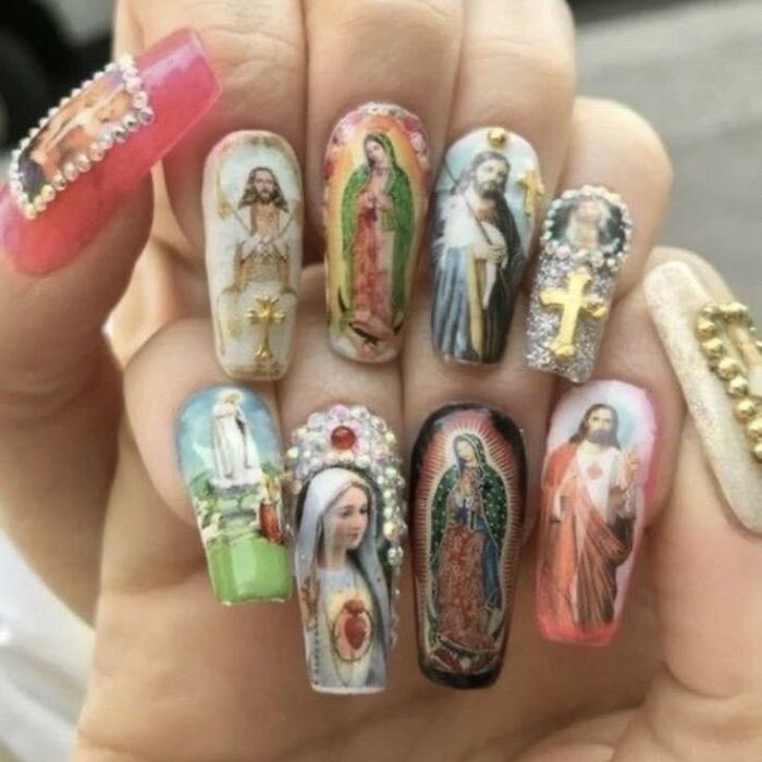 Nail art featuring religious and cultural icons mixed with decorative elements in a chaotic and creative style.