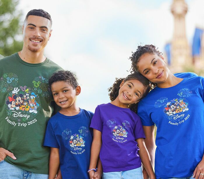 Family of four wearing Disney Family Trip 2025 shirts, smiling outdoors showing trends related to overconsumption concerns. - 19