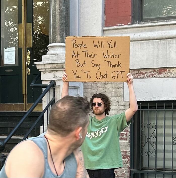 Man holding sign with message about people yelling at waiters but thanking Chat GPT, capturing Dude With The Sign humor.