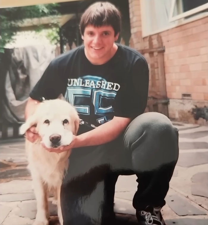 Young man crouching outside with a golden retriever dog, related to reality star charged with murder case.