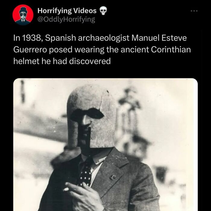 Spanish archaeologist in 1938 wearing an ancient Corinthian helmet, an oddly horrifying and unsettling image.