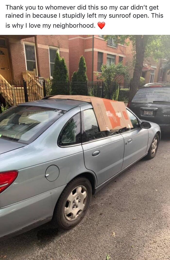 Silver car with a cardboard cover over its open sunroof showing the beauty of planet earth and neighborhood kindness.