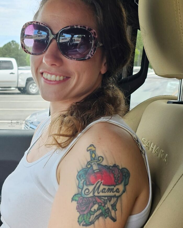 Smiling woman with sunglasses showing a colorful tattoo on her arm, related to woman who mysteriously vanished in Death Valley. - 9