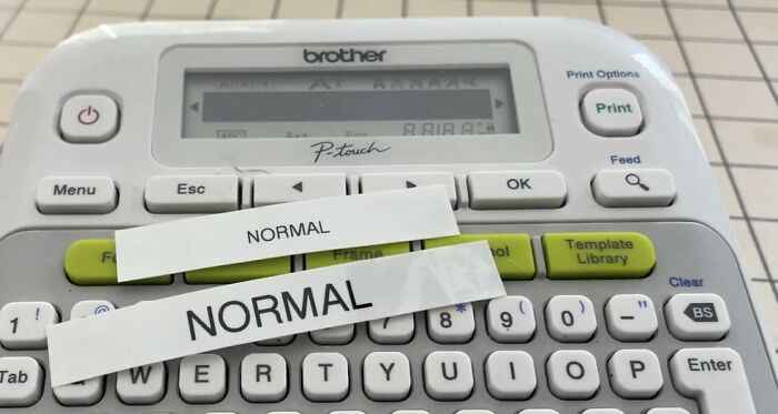 Label maker printing NORMAL labels on a keyboard, showcasing a popular infomercial find watched on sick days.