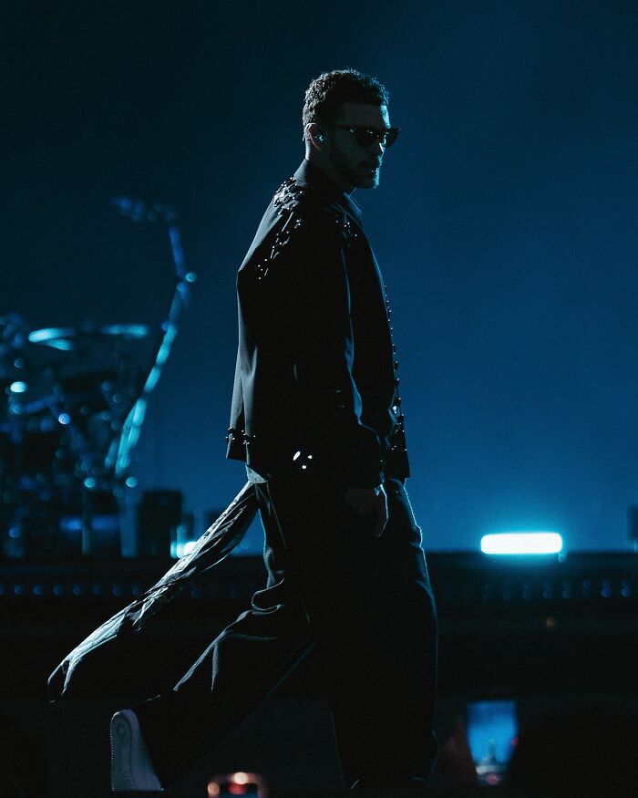 Justin Timberlake performing on stage during his controversial Romania show facing fan backlash and refund demands.