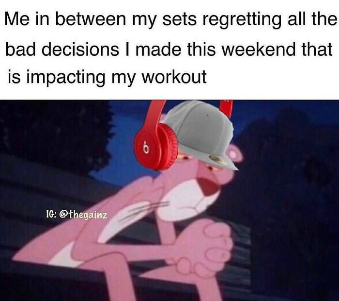 Pink Panther wearing red headphones and a gray cap, looking tired and reflective during a gym workout rest period.