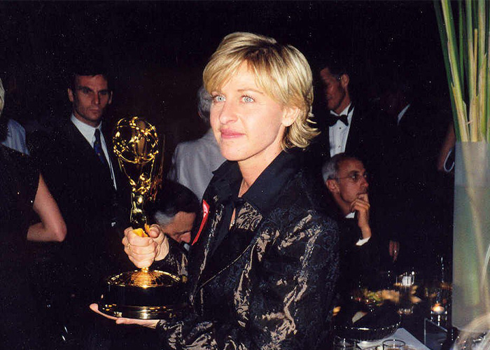 Woman holding a golden award trophy at a formal event, related to former employees revealing crazy secrets at work. - 4