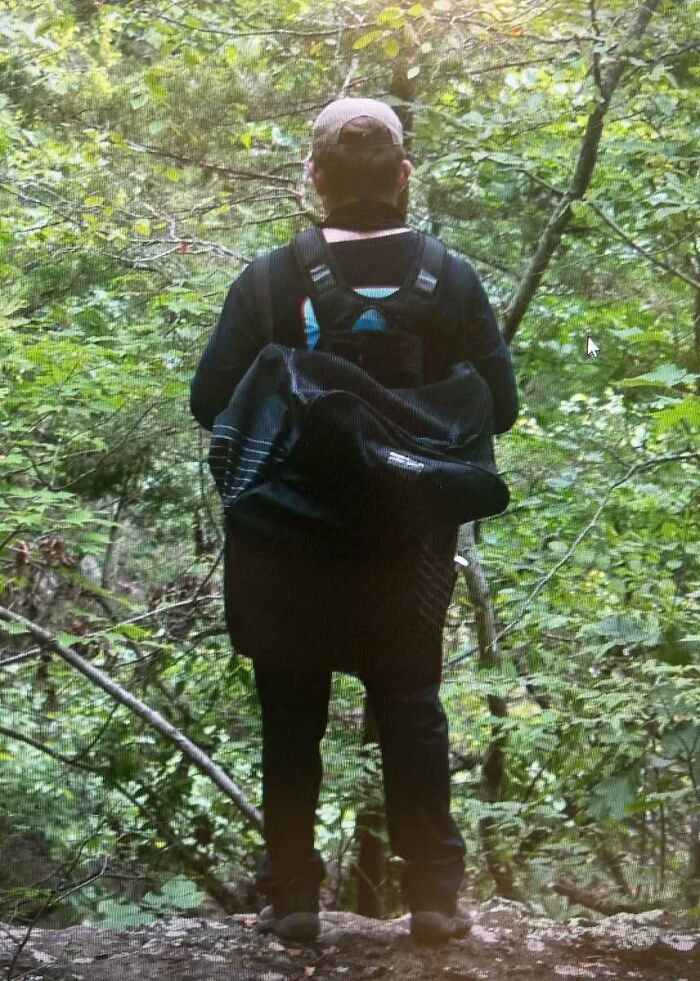 Person wearing a backpack hiking in dense forest, related to suspect nabbed in Devil's Den case after couple slayed. - 7