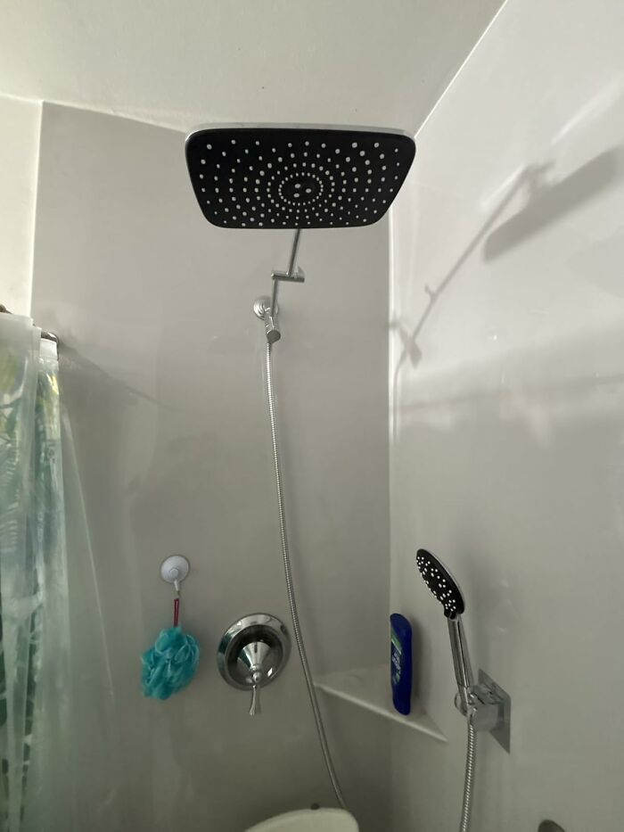 Modern black square showerhead and handheld sprayer in a bathroom, one of the most wished for items burning up Amazon.