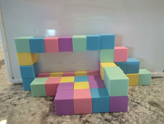 Colorful Prime Day treasures arranged in a rectangular shape on a granite surface against a white background.