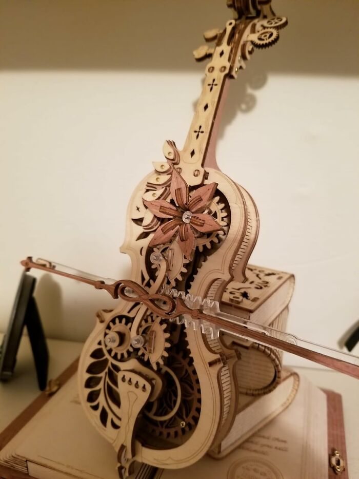 Intricately crafted wooden mechanical model violin showcasing skill-building hobbies for trading screen time.