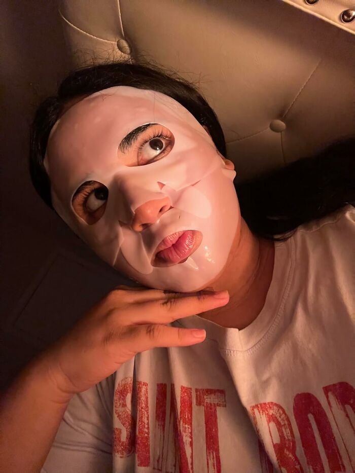 Person wearing a skincare sheet mask, one of the most wished for items burning up Amazon this week.