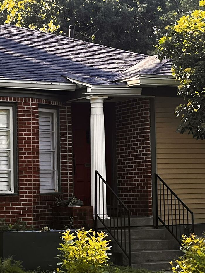 House kreatively modified with mismatched siding and broken roof detail, example of creative home design fail.