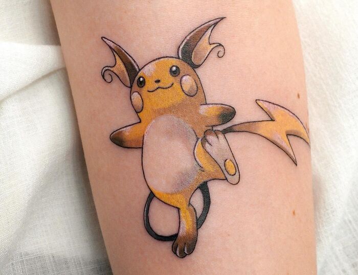 Colorful Raichu tattoo on arm showcasing one of the best tattoos with vibrant detail and playful design.