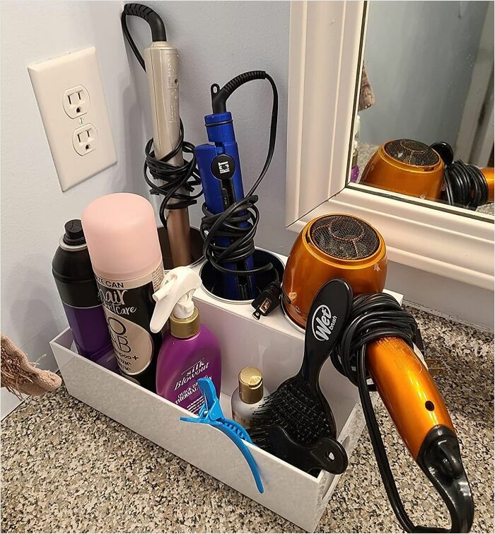 Organized hair tools and products in a countertop organizer for frantic panic cleaning style before guests arrive.