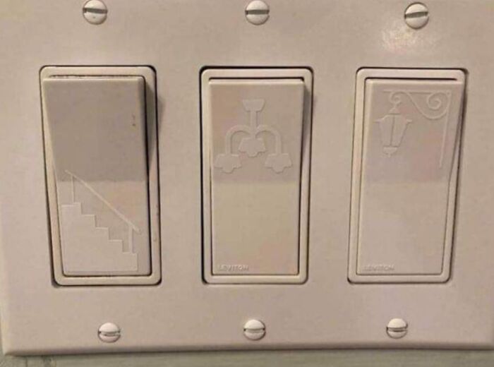 Light switches with clever icons indicating stairs, chandelier, and lantern, showcasing genius real-world designs.