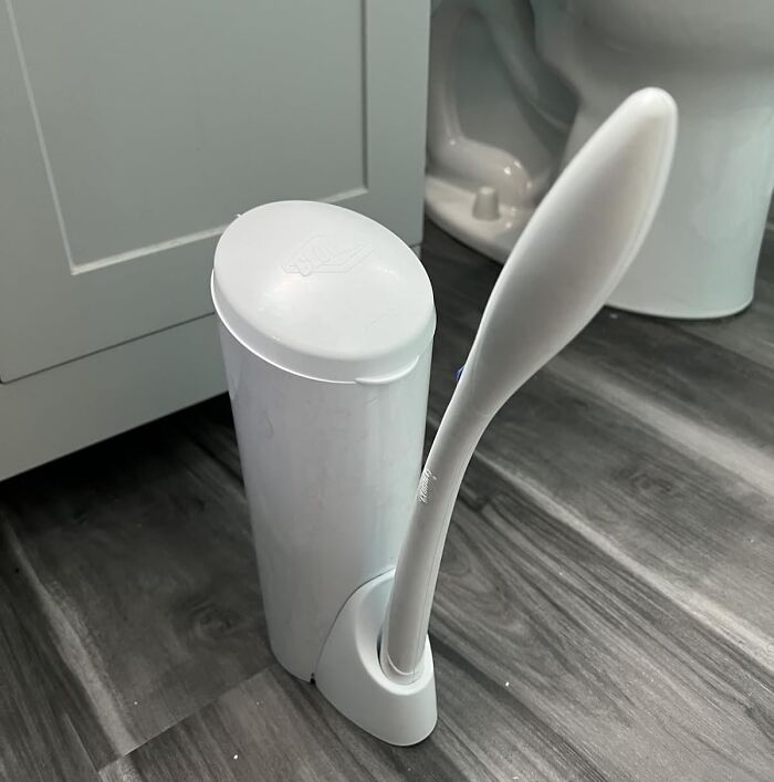 White modern toilet brush and holder set on a gray bathroom floor featuring 5-star Prime Day finds.