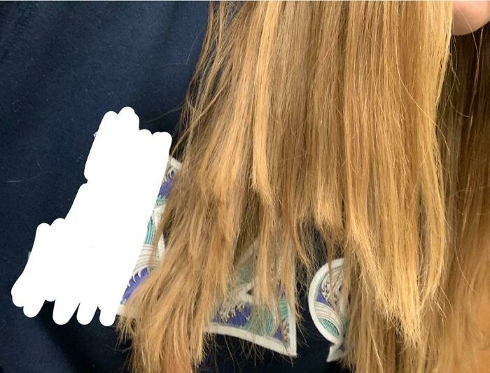 Close-up of damaged blonde hair showing uneven lengths and frizz after a salon visit, highlighting a glow-up gone wrong.