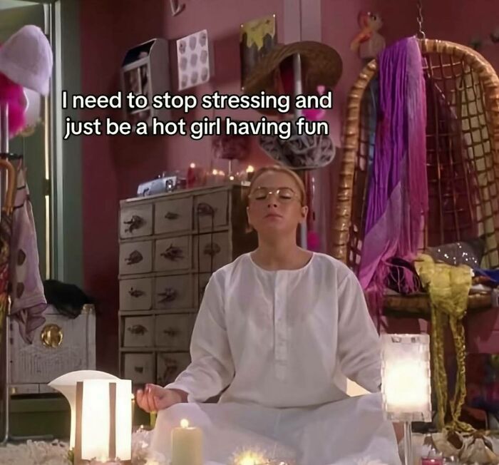 Woman in white outfit meditating surrounded by candles in a colorful room, funny and relatable memes for girly women.