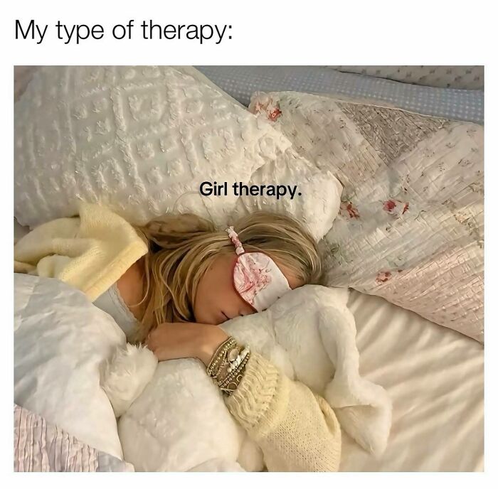 A girly woman wearing a sleep mask resting on a bed with soft pillows and cozy blankets, enjoying her type of therapy.