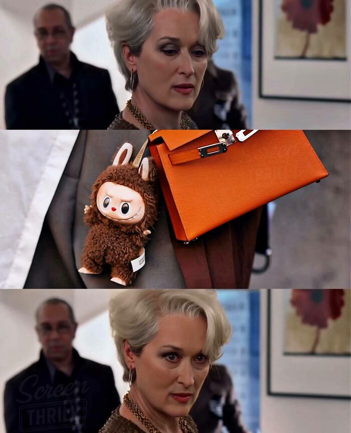 Woman with short blonde hair wearing gold jewelry and carrying an orange handbag with a cute plush keychain for girly women memes.