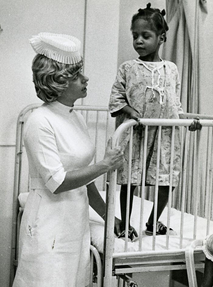 Vintage nurse in uniform caring for a young patient in a hospital, reflecting vintage photos of nurses bringing healing and hope.