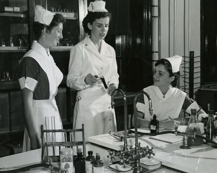 Three vintage nurses in uniform working together in a laboratory setting, showcasing healing and hope.