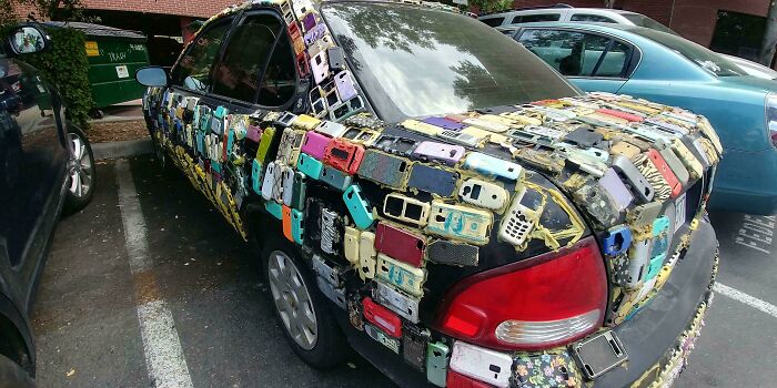 Car covered in outdated mobile phone cases as part of outrageous car mods that took things way too far.