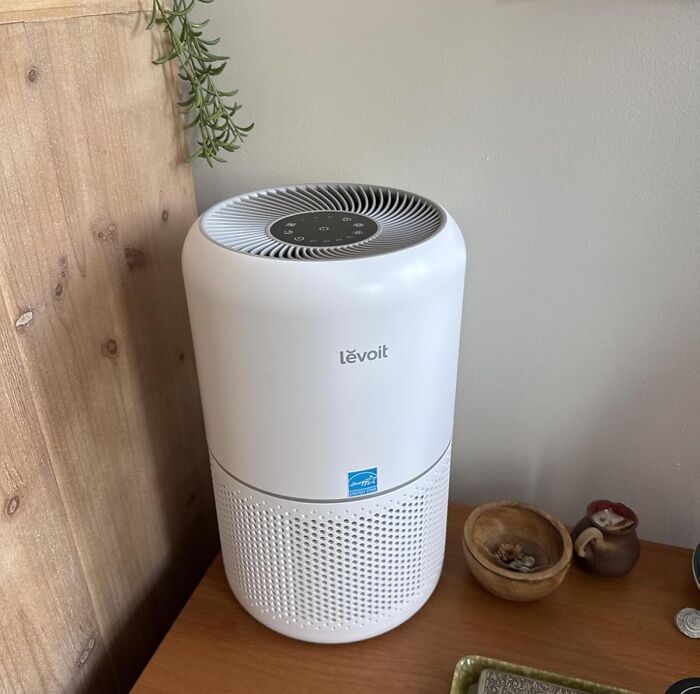 Levoit air purifier on wooden surface, showcasing popular Prime Day electronic deals for smart home shopping.